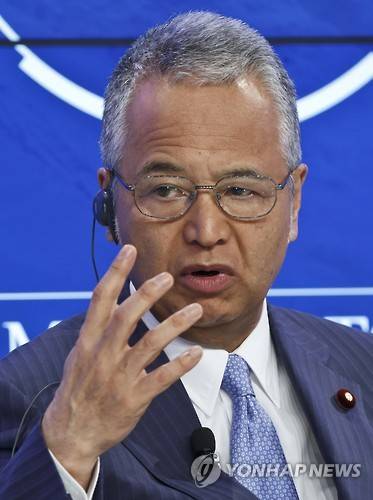Japan's Economy Minister Akira Amari gestures as he speaks during a panel "Japan's Future Economy" at the World Economic Forum in Davos, Switzerland, Saturday, Jan. 23, 2016. at the World Economic Forum in Davos, Switzerland, Friday, Jan. 22, 2016. World leaders are holding a flurry of diplomatic meetings at the World Economic Forum and worried CEOs are debating about how to deal with this year's volatile markets and low oil prices.(AP Photo/Michel Euler)