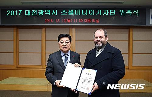 【대전=뉴시스】조명휘 기자 = 권선택 대전시장이 12일 시청 대회의실에서 열린 '2017 대전시 소셜미디어기자단 위촉식'에 참석한 외국인에게 외촉장을 수여하고 있다. 2016.12.12. (사진= 대전시 제공)   photo@newsis.com
