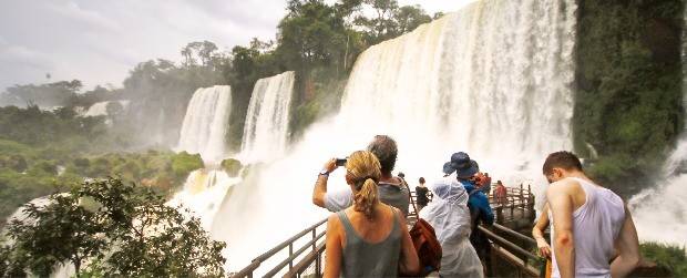 전망대에서 폭포 사진을 찍고 있는 여행객들