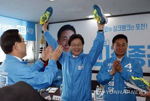 (포천=연합뉴스) 우영식 기자 = 30일 오전 보궐선거가 치러지는 경기도 포천시 정종근 바른정당 후보 선거사무실에서 열린 바른정당 현장 지도부 회의에 참석한 유승민 대선후보(가운데)가 당 지도부가 열심히 뛰라며 전달한 운동화 들고 환하게 웃고 있다. wyshik@yna.co.kr