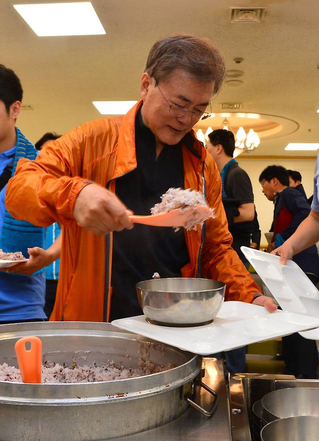 청와대 직원식당에서 직접 밥을 푸고 있는 문 대통령.
