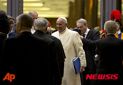 Pope Francis leaves at the end of the Synod of bishops, at the Vatican, Saturday, Oct. 24, 2015. Catholic bishops were voting Saturday on a final document to better minister to families following a contentious, three-week summit at the Vatican that exposed deep divisions among prelates over Pope Francis' call for a more merciful and less judgmental church. (AP Photo/Alessandra Tarantino)