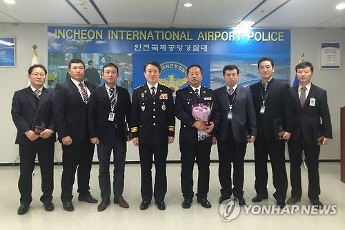 인천공항 협박범 검거 주역들 (인천=연합뉴스) 권숙희 기자 = 강신명 경찰청장(왼쪽에서 네번째)이 4일 인천공항경찰대에서 '인천공항 폭발물 의심 물체 사건'의 피의자 검거에 공로를 세워 특진한 인천청 광역수사대 김순천 경위(가운데) 등과 기념촬영을 하고 있다.