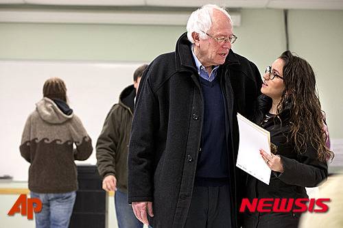 Democratic presidential candidate Sen. Bernie Sanders, I-Vt., is hugged by a voter after voting in the Vermont primary at the Robert Miller Community and Recreation Center in Burlington, Vermont, Tuesday, March 1, 2016, on Super Tuesday. (AP Photo/Jacquelyn Martin)???