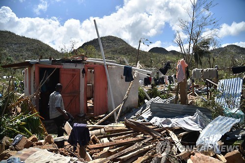 7일(현지시간) 아이티 서남 해안 항구도시 레카예스 인근에서 한 주민이 허리케인 매슈에 무너져 내린 집을 바라보고 있다. [AFP=연합뉴스]