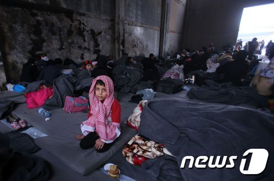 알레포 반군 지역을 탈출한 한 시리아 소년이 피란민 수용 시설에 앉아 있다. © AFP=뉴스1