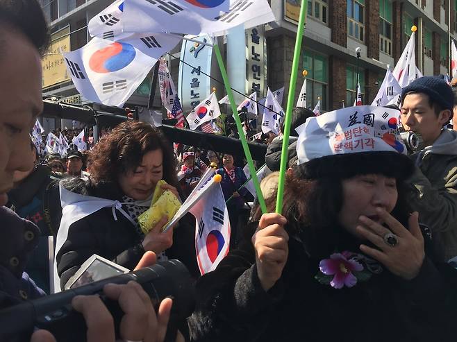 10일 오전 헌법재판소가 박근혜 대통령 탄핵 인용을 결정하자 탄핵반대 집회 참가자가 눈물을 훔치고 있다. 박수지 기자