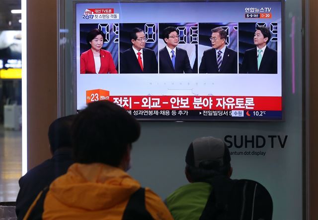 19일 오후 서울역에서 시민들이 대선후보 TV토론 방송을 시청하고 있다.  연합뉴스