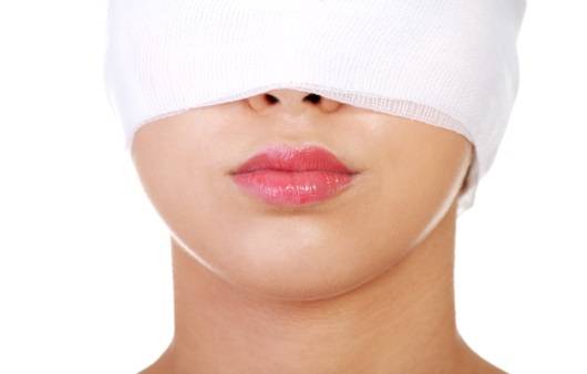 눈에 붕대를 감은 여성