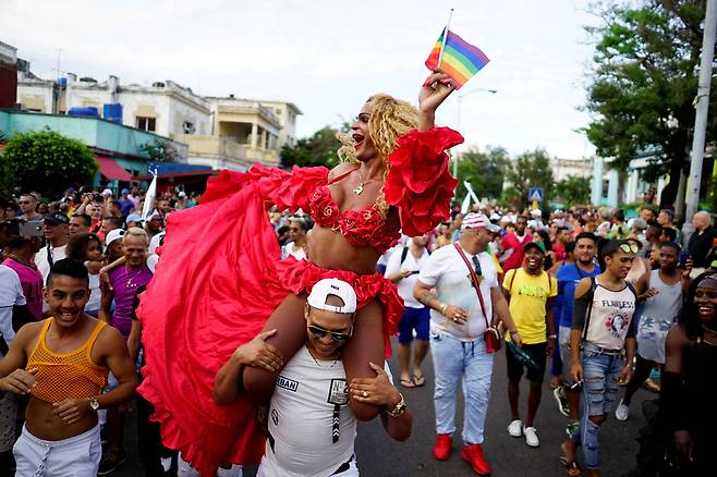 동성애자 인권 운동가들이 12일(현지시간) 쿠바 하바나에서 열린 LGBT 퍼레이드에 참가해 무지개 깃발을 들고 행진을 하고 있다. 이 퍼레이드는 다가오는 성소수자 혐오 반대의 날인 5월 17일을 기념하기 위해 열렸다. [로이터=연합뉴스]