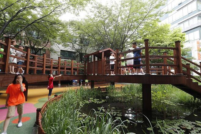 서울시 중랑구 신현초에 마련된 학교 놀이터. 이 학교 놀이터에는 학생들의 의견을 반영해 연못 위에 나무집(트리하우스)를 만들었다. 이정아 기자 leej@hani.co.kr