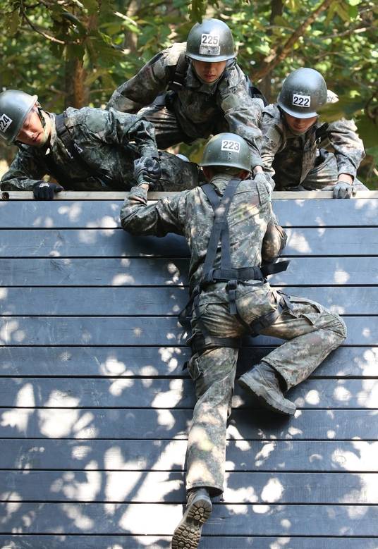 4명의 생도들이 서로 도와 전우와 함께 담장넘기 코스를 실습하고 있다. /남강호 기자