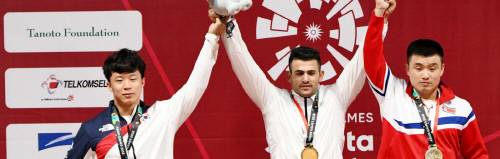 이라크 역도 금메달리스트 라시드 마흐무드가 한국과 북한 선수들을 사이에 두고 금메달을 자축하고 있다. 출처 | 아시안게임 홈페이지