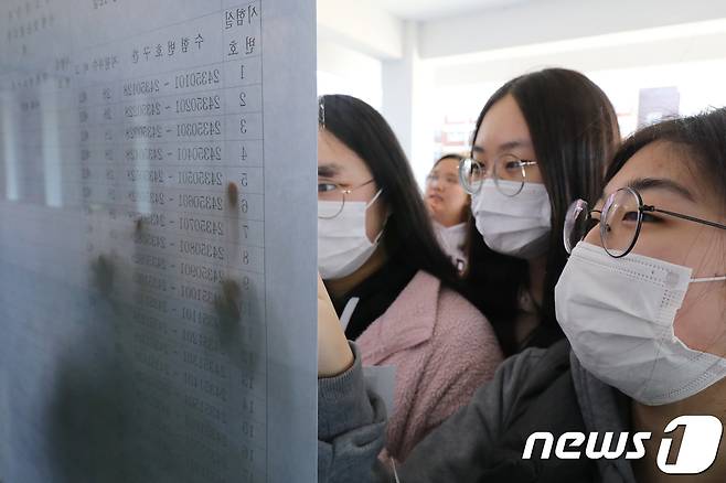 2019학년도 대학수학능력시험 하루 전인 14일 오후 대구 달서구 경화여자고등학교에서 마스크를 쓴 수험생들이 수험번호와 시험실을 확인하고 있다. /뉴스1 © News1