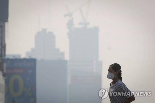 초미세먼지로 수주 째 몸살을 앓는 방콕 시내를 한 시민이 걸어가고 있다(19.1.21) [EPA=연합뉴스]