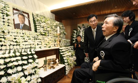 김대중 전 대통령이 서거한 2009년 8월 18일 서울 연세대 세브란스병원 장례식장에 마련된 김 전 대통령의 빈소에서 장남 김홍일 전 의원이 휠체어에 몸을 의지하며 분향하고 있다.