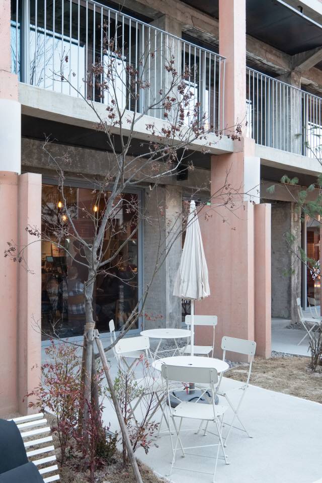 1층 중정을 따라 늘어선 두꺼운 분홍빛의 기둥은 일종의 모뉴먼트로 건축물의 기억을 잇는 건축적 조형물이다. /사진제공=푸하하하프렌즈, 석준기 사진작가