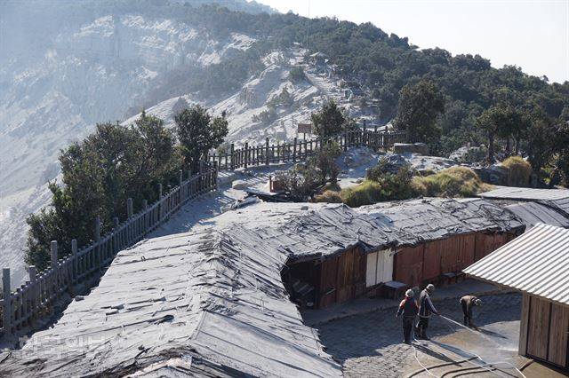지난 26일 분출한 인도네시아 서부자바주의 탕쿠반 프라후 분화구 위에 늘어선 노점 지붕이 화산재로 뒤덮인 29일 모습. 름방=고찬유 특파원