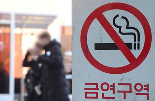 지난해 2월17일 오후 서울 용산구 서울역 광장에서 흡연자들이 흡연 부스 밖에서 담배를 피우고 있다. 금연구역을 알리는 팻말에도 이처럼 광장에서 흡연하는 이들은 적지 않았다.&nbsp;김경호 기자
