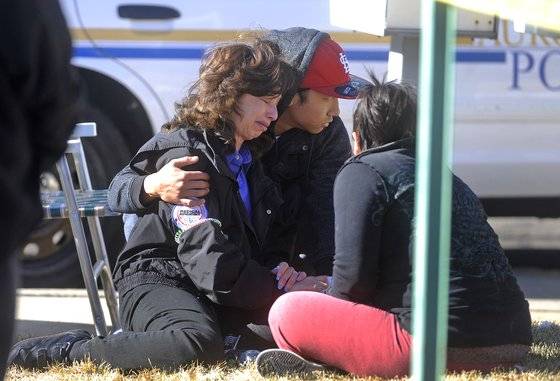 2012년 미국 콜로라도주 덴버의 인근 도시 오로라에서 발생한 조커 캐릭터 모방 총기난사사건의 희생자 가족들이 바닥에 주저앉아 흐느끼고 있다. [로이터=연합뉴스]