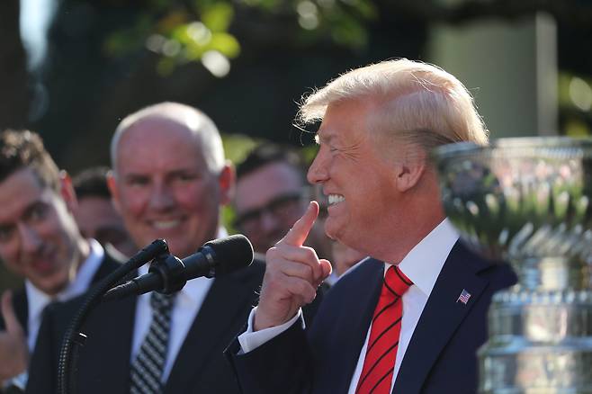 도널드 트럼프 미국 대통령이 15일(현지시간) 워싱턴 D.C. 백악관 로즈가든에서 열린 올해 북미아이스하키리그(NHL) 스탠리컵 우승팀 초청행사에서 자신의 치아를 가리키고 있다. [로이터=연합뉴스]