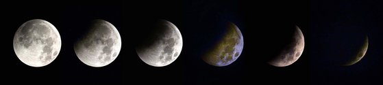 태양과 지구, 달이 일직선에 놓인 28일 새벽 보름달이 지구 그림자에 완전히 가리는 개기월식이 대전 상공에서 관측됐다. [중앙포토]