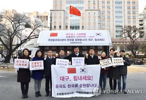 싱하이밍 주한중국대사와 대사관 직원들이 2020년 2월 27일 대구시에 전달하는 의료용 마스크 2만5천여개를 실은 트럭 앞에서 '대구, 힘내세요! 중국도 한국을 응원합니다!'가 적힌 현수막을 들고 있다. [연합뉴스 자료사진]