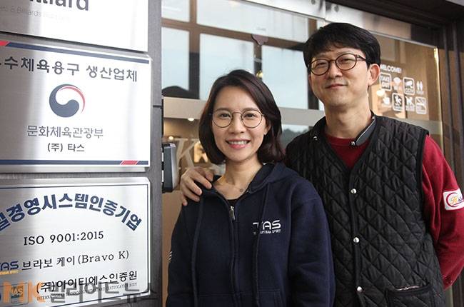 강태경 대표와 남편 유기윤씨가 타스 사무실 앞에서 기념촬영하고 있다.
