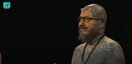 덴마크의 어린이 프로그램 '울트라 스트립스 다운(Ultra Strips Down)'에서 온몸에 문신을 한 자원봉사자가 질문에 답하고 있다. [해당 프로그램 유튜브 화면 캡쳐]