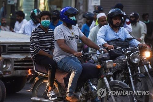 파키스탄 카라치에서 오토바이를 타고 이동 중인 주민. 일부는 마스크를 착용하지 않았다. [AFP=연합뉴스]