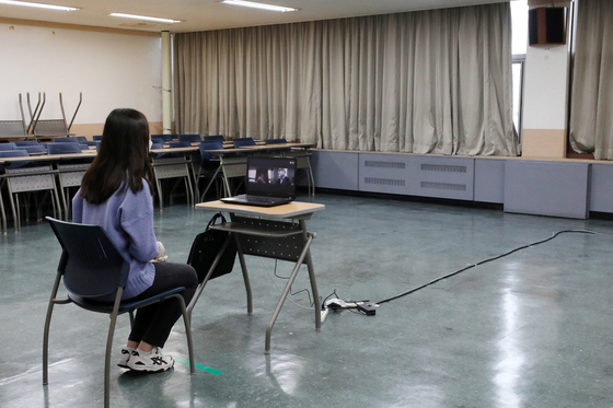 A student sits for a virtual interview for early admissions at the Hankuk University of Foreign Studies in eastern Seoul on Sunday. [NEWS1]