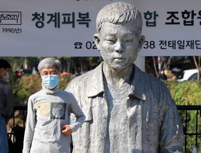 20일 오전 서울시 종로구 청계천 전태일다리에서 열린 `한진중공업 해고자 김진숙의 복직촉구 기자회견 종료 후 김진숙씨가 전태일 동상 앞에서 기념촬영을 하고 있다.