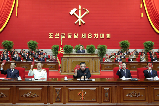 North Korean leader Kim Jong-un, center, and top party officials sit at a leadership podium to mark the opening of the 8th Congress of the ruling Workers' Party on Tuesday. [NEWS1]