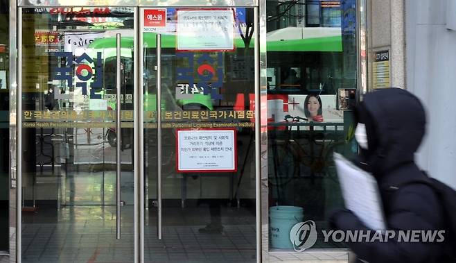 의대생에 '의사국시' 추가 시험 기회 부여 (서울=연합뉴스) 최재구 기자 = 정부가 내년 하반기로 예정된 의사 국가고시 실기 시험을 상·하반기로 나눠 2차례로 치르기로 했다고 발표한 지난해 12월 31일 서울 광진구 한국보건의료인국가시험원 앞으로 한 시민이 지나고 있다. jjaeck9@yna.co.kr