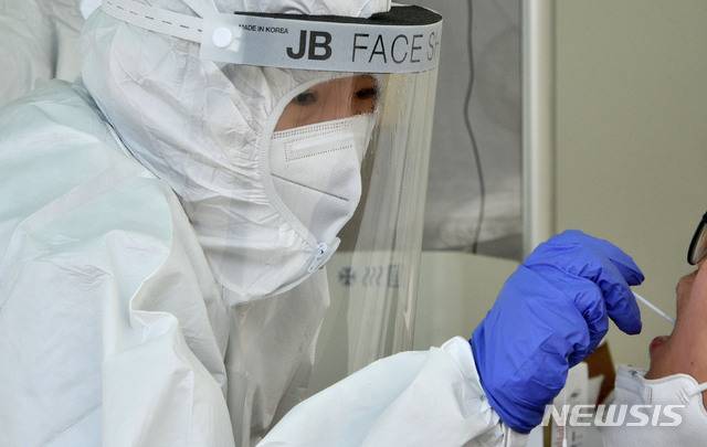 [천안=뉴시스] 이종익 기자 = 신종 코로나바이러스 감염증(코로나19) 임시선별진료소에서 의료진이 검체를 채취하고 있다. 뉴시스DB.