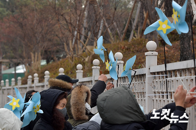 대한아동학대방지협회원들이 11일 서울 양천구 서울남부지방검찰청 담벼락에 정인양을 추모하고 가해자에 대한 엄벌을 요구하는 취지가 담긴 바람개비를 설치하고 있다. 박종민 기자