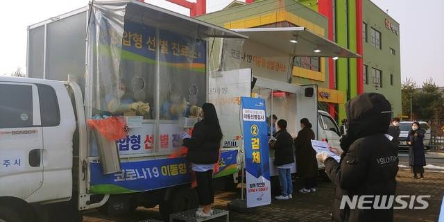 [파주=뉴시스]이호진 기자 = 13일 오후 경기 파주시 문산읍 선유산업단지 공원에서 운영된 이동형 선별검사소에서 공단 직원들이 검체 채취를 받고 있다. 이날 하루 현장 접수인원 제외한 공단 근로자 430여명이 이 곳에서 예약검사를 받았다. 2021.01.13. asake@newsis.com