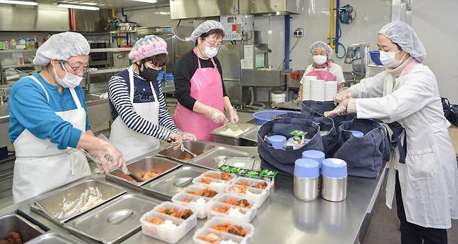 경기도 성남시 하얀마을복지회관 경로식당에서 영양사와 지역 봉사자들이 도시락을 만드는 모습 /사진=SK(주) C&C