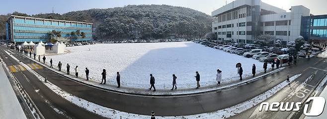 경기도 수원시 팔달구 경기도청에서 지난 13일 공무원들이 신종 코로나바이러스 감염증(코로나19) 검사를 받기 위해 줄을 길게 서 있다./뉴스1 © News1 이재명 기자