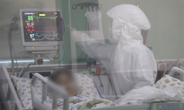 지난 20일 울산대병원 특수(음압)중환자실에서 방호복을 착용한 의료진이 환자를 돌보고 있다. 뉴스1