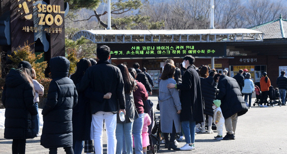 전국 대부분 지역의 기온이 영상권으로 올라간 24일 경기도 과천시 서울대공원으로 나들이 나온 시민들이 입장을 하기 위해 줄지어 서 있다. 2021.1.24 오장환 기자 5zzang@seoul.co.kr