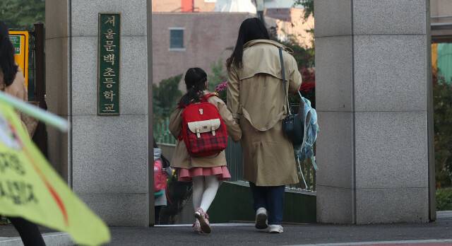 지난해 10월19일 오전 서울 금천구 문백초등학교에서 초등학교 1학년 학생이 등교하고 있다. 박종식 기자 anaki@hani.co.kr