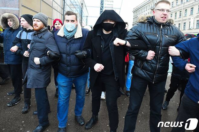 1월31일 (현지시간) 상트페테르부르크에서 러시아 야권 운동가 알렉세이 나발니를 지지하는 시위대가 팔짱을 끼고 경찰과 대치를 하고 있다. © AFP=뉴스1 © News1 우동명 기자