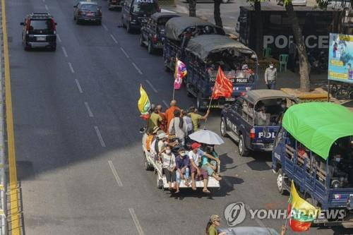 양곤에서 미얀마 국기와 군부 깃발을 흔들며 차를 타고 지나가는 지지자들. [AP=연합뉴스]