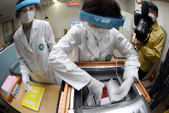 Medical staff at a public health center in Gwangju check the first batch of AstraZeneca vaccines Thursday, two days before the start of vaccinations in Korea.