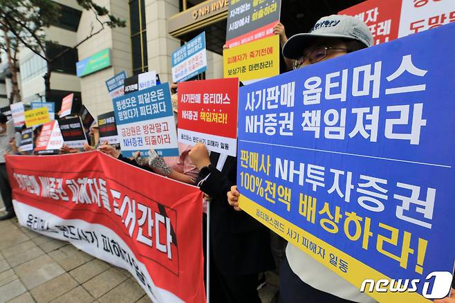 옵티머스 펀드 NH투자증권 피해자들이 23일 오전 서울 여의도 NH투자증권 앞에서 '사기판매'를 규탄하고 있다. 2020.7.23/뉴스1 © News1 구윤성 기자