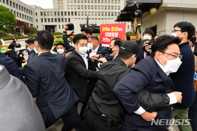 [서울=뉴시스]국회사진기자단 = 주호영 국민의힘 당 대표 권한대행과 당 의원들이 23일 오전 서울 서초구 대법원 정문 앞에서 김명수 대법원장의 사퇴 촉구 공동선언 기자회견을 한 뒤 김 대법원장이 탄 차량이 나타나자 항의를 하고 있다. 2021.04.23. photo@newsis.com