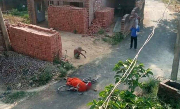 인도의 한 노인이 코로나19로 사망한 아내의 시신을 자전거로 옮기다 힘에 부쳐 떨어뜨리고선 길가에 주저앉아 있다.