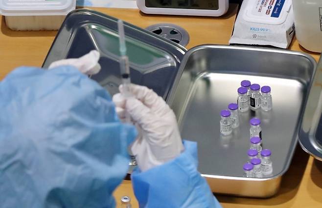 광주 북구 예방접종센터에서 의료진들이 화이자 백신을 주사기에 나눠담고 있다. 연합뉴스 제공