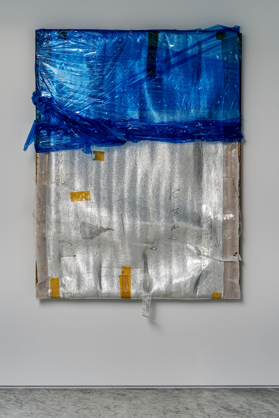 Bek's mixed media "Welcome, Welcome!" is a wrapped portrait. [PKM GALLERY]